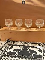 All four cut crystal brandy glasses on shelf