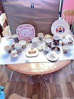 Group shot of all commemorative tableware on round table
