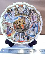 Front of 40th Anniversary plate showing multiscene design and gold rim with ruler for scale