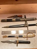 All five daggers with ruler for scale