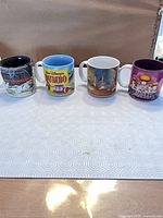 Front view of four Disney mugs lined up