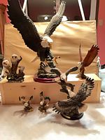 Group view of all seven resin eagle figurines