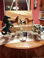 Group shot of all figurines, mugs, sugar bowl and dish on table