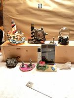 Group view of all lighthouse figurines, minerals and frame