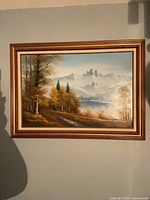 Full view of framed oil landscape painting on wall