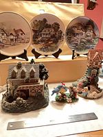 Overview of three plates on stands plus four resin figurines