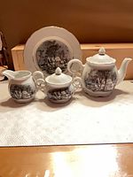 Full set showing teapot, covered sugar bowl, creamer and plate