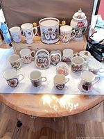 Full lot showing mugs, stein, pot and dishes on display