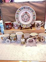 Overall lot showing plate, mugs, plaques, decanter