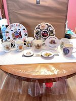 Group shot of all mugs, plates and dishes on table