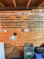 Wall display of multiple model locomotive bodies arranged on wooden slats