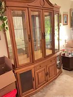 full view of oak buffet hutch showing upper glass cabinet and lower buffet