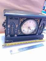 Front angled view showing entire clock and measuring tape