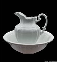 pitcher resting inside matching bowl