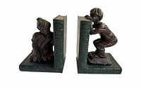 Front view of both bronze boy and girl hide and seek bookends with green marble book-shaped bases