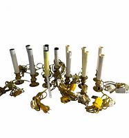Group of 14 electric brass window candle lights with cords visible