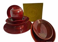 Front view of all six red and green resin-coated wooden pieces