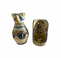 Front view of sangria pitcher and matching wall candleholder showing motif and form