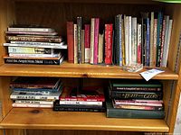 Overall view of pine bookcase filled with books on two shelves