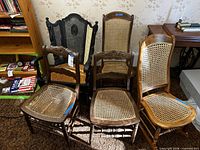 Group view of five antique wooden chairs