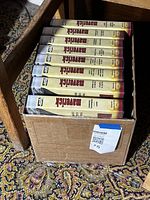 Box of eight Maverick Collector's Edition VHS tapes in slipcases