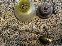 glass shade, canopy, chain with socket displayed on rug