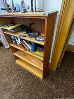 Full view of pine bookshelf with visible contents