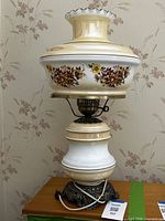 Full view of vintage hurricane-style table lamp showing shade, body and base