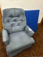 Front view of La-Z-Boy chair beside blue mat