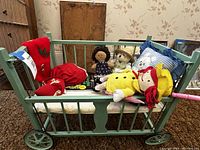 Overall view of crib, bedding and all plush/dolls