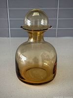 Front view of amber glass jar with lid assembled