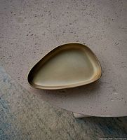 Top view of irregular triangular aluminum tray on tabletop