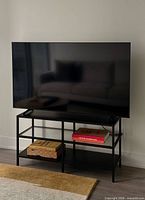 Full view of Samsung TV on metal stand