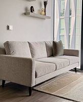 Front angle view of Santana sofa showing full frame, cushions, legs and placement