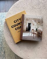 Both hardcover books stacked: City Country Coast and Sense of Place