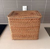 Front view of rectangular woven basket with lid