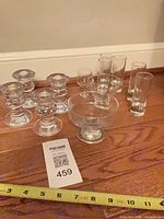 Full lot showing candle holders, bowls, shot glasses with measuring tape for scale