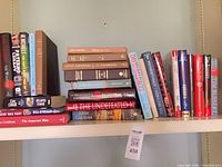 Shelf view of entire lot showing assorted hardcover books