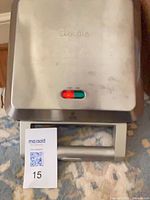 Closed Breville pastry maker exterior showing logo and indicator lights