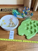 Group shot of plates, bowl and egg tray with measuring tape for scale