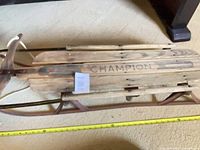 Full side view of Champion wooden sled showing overall structure