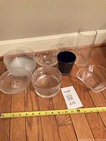 All seven glassware pieces with measuring tape for scale