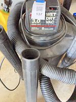 Vacuum with hose and wands visible