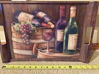 Front view of wooden tray with wine artwork and tape measure for size reference