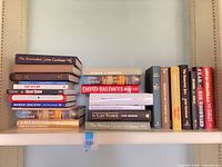 Left stack of horizontally placed hardcovers