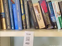 Left section of shelf showing John Grisham titles and Alex Haley’s Roots