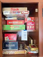 Cabinet shelf holding all boxed games stacked