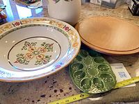 Overview of all four items: ceramic bowl, pitcher, wooden turntable, green egg platter