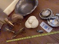 Group showing all dishes and figurines with tape for scale