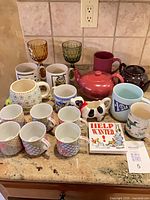 Full lot view showing mugs, teapots, goblets, creamer, novelty pitcher